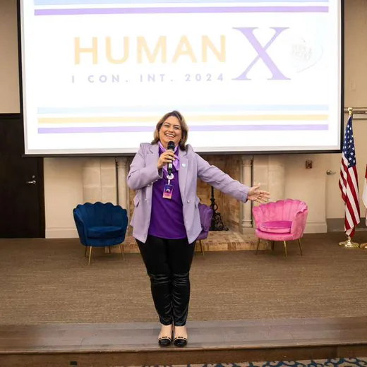 On stage at Human X, in front of the conference screen and the U.S., Brazilian and Florida flags