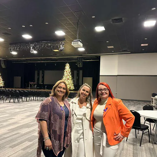 Three members of the team in the conference hall
