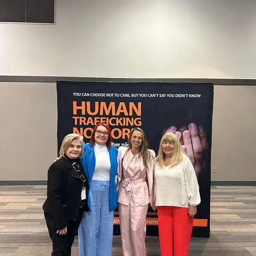Four guests in front of the “Human trafficking no more” panel