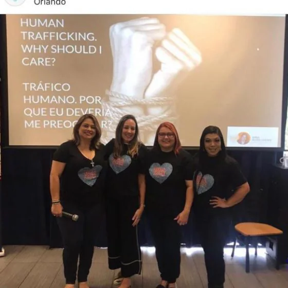 A lecture slide reading “Human trafficking. Why should I care?” with the audience in front of it