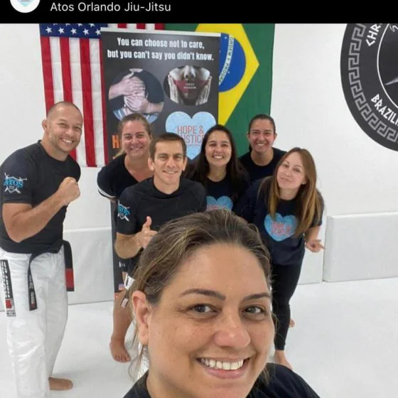 Training group photographed beside the flags and the awareness poster