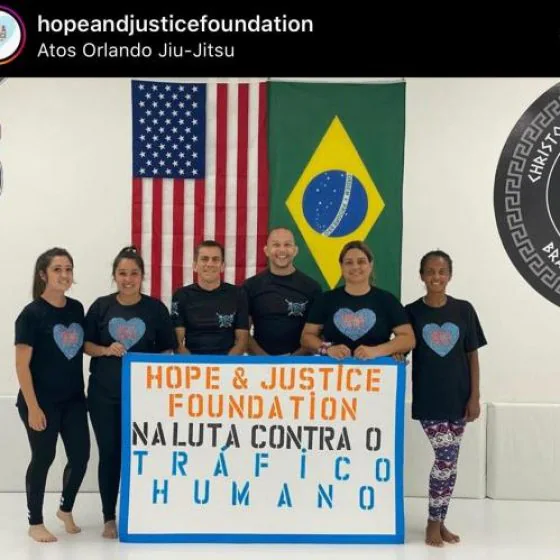 The group holds a hand-painted banner about the fight against human trafficking
