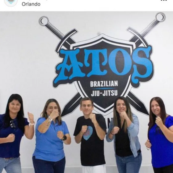 Five participants in a guard stance under the academy logo
